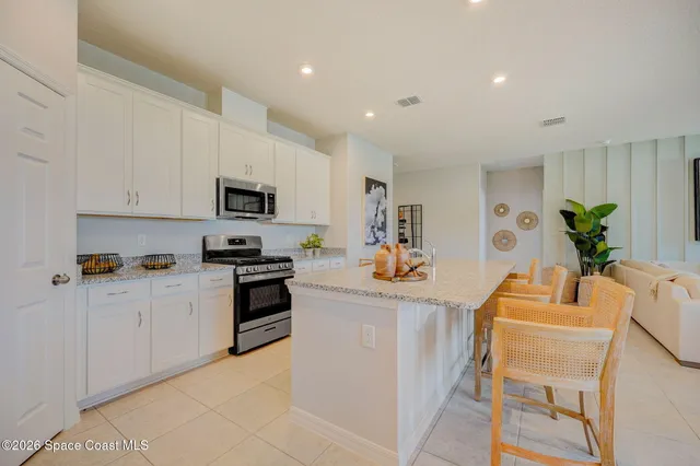 a kitchen with appliances a counter space and cabinets