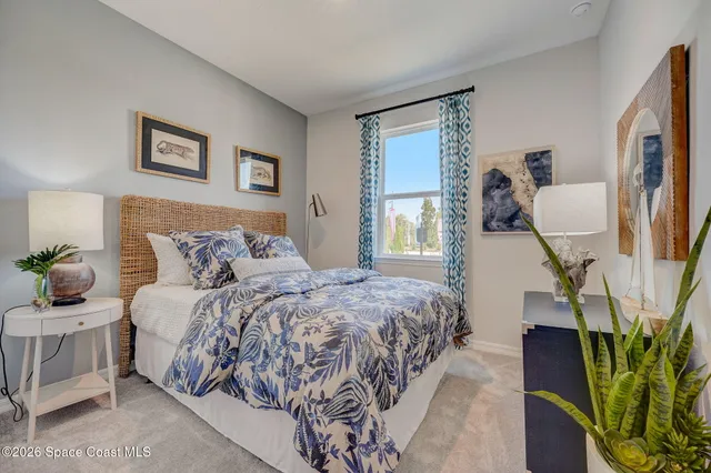 a bedroom with bed and window