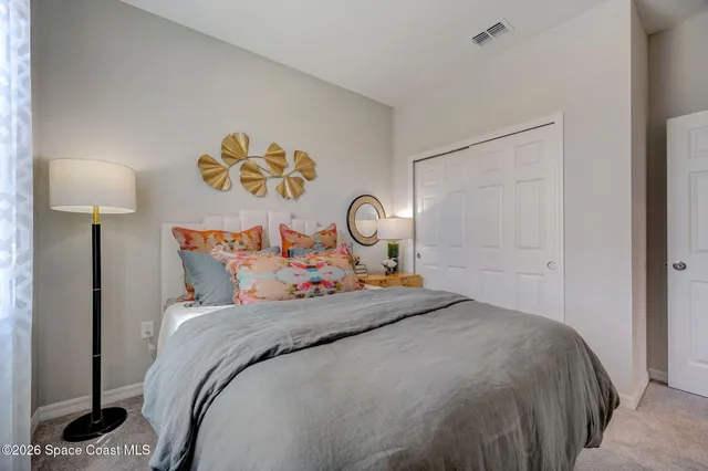 a bedroom with a bed and a lamp on table
