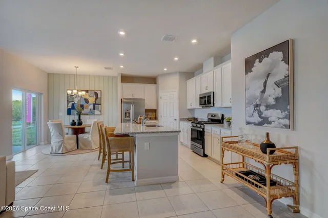 a kitchen with cabinets and chairs