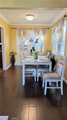 a view of a dining room with furniture and a chandelier