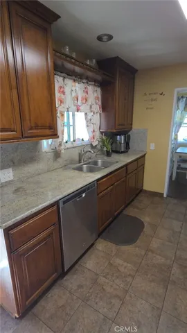 a kitchen with stainless steel appliances granite countertop a sink and cabinets