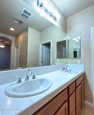 a bathroom with a double vanity sink and a mirror