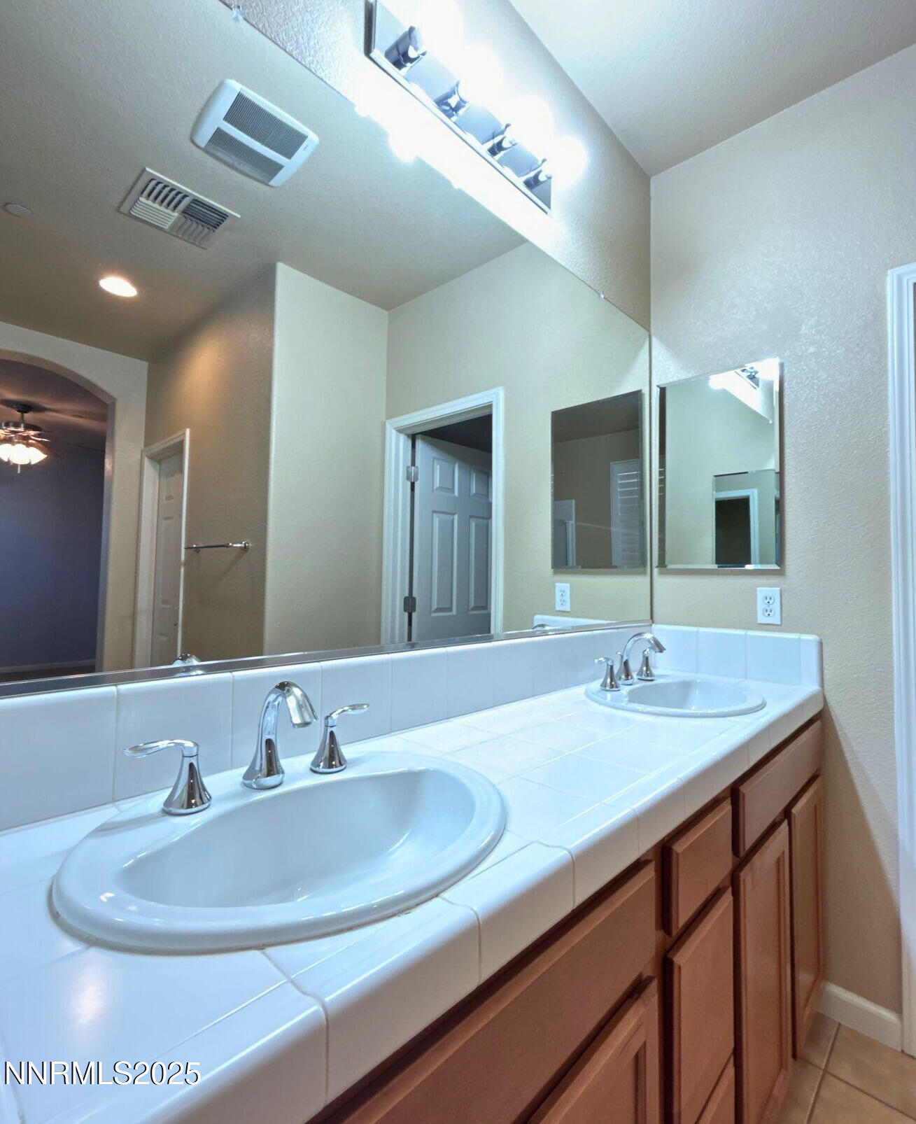 1828 Wind Ranch Road, Unit B Reno, NV 89521 - Photo 11 of 19 a bathroom with a double vanity sink and a mirror