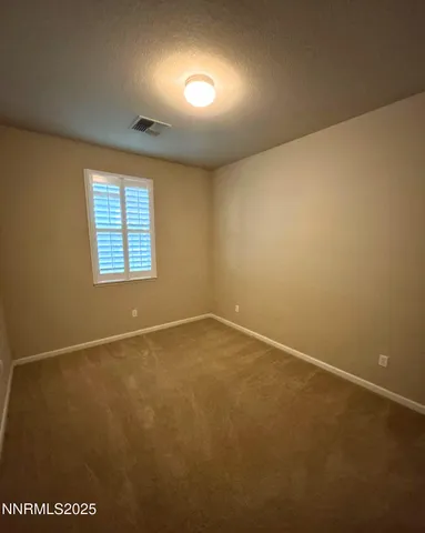 an empty room with a empty space and windows