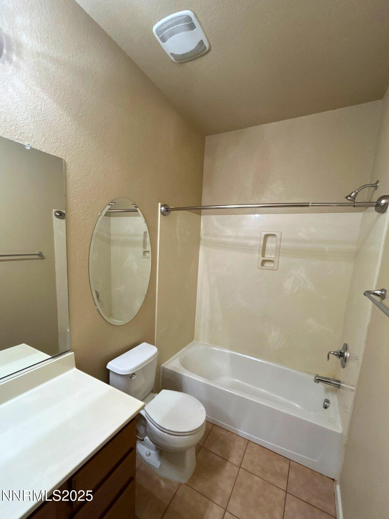 1828 Wind Ranch Road, Unit B Reno, NV 89521 - Photo 15 of 19 a bathroom with a granite countertop toilet sink mirror vanity and bathtub