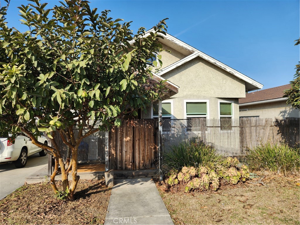 a view of a house with a tree in the background