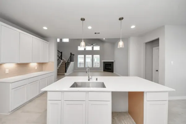 a kitchen with a sink counter top space and cabinets