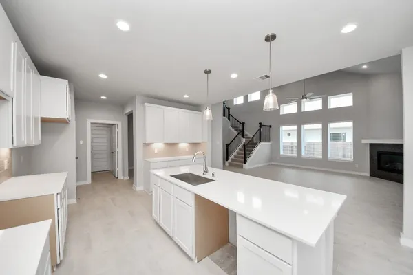 a kitchen with a refrigerator a sink and a large window