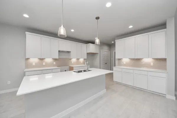 a large kitchen with kitchen island a sink stainless steel appliances and cabinets
