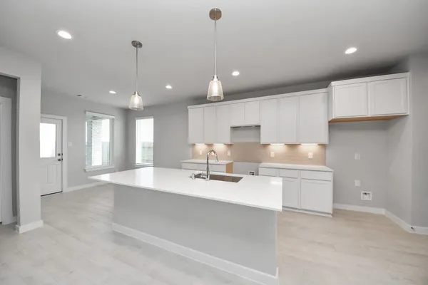 a large white kitchen with a large window