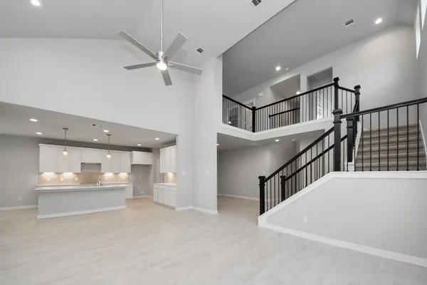 an empty room with a ceiling fan and window