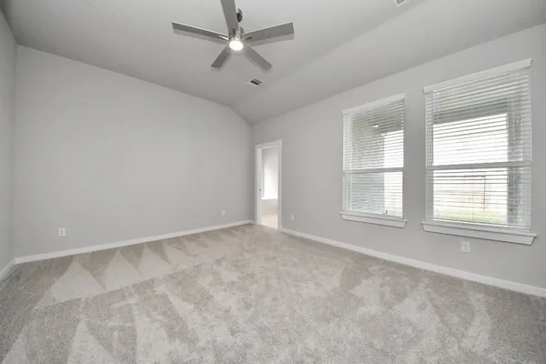 a spacious bathroom with a shower a sink and a mirror