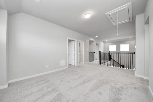 an empty room with windows and closet