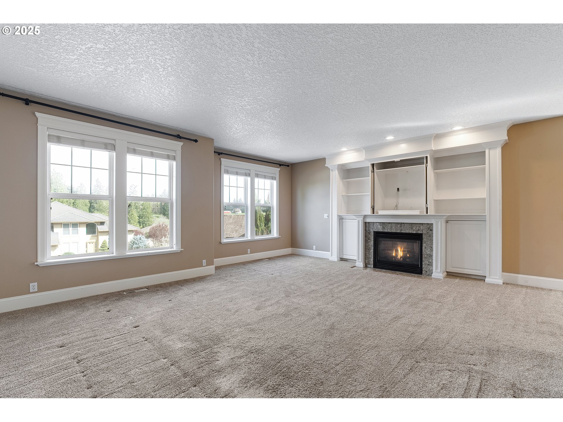 2947 Southeast Maple Place Gresham, OR 97080 - Photo 13 of 46 a view of an empty room with a fireplace and a window