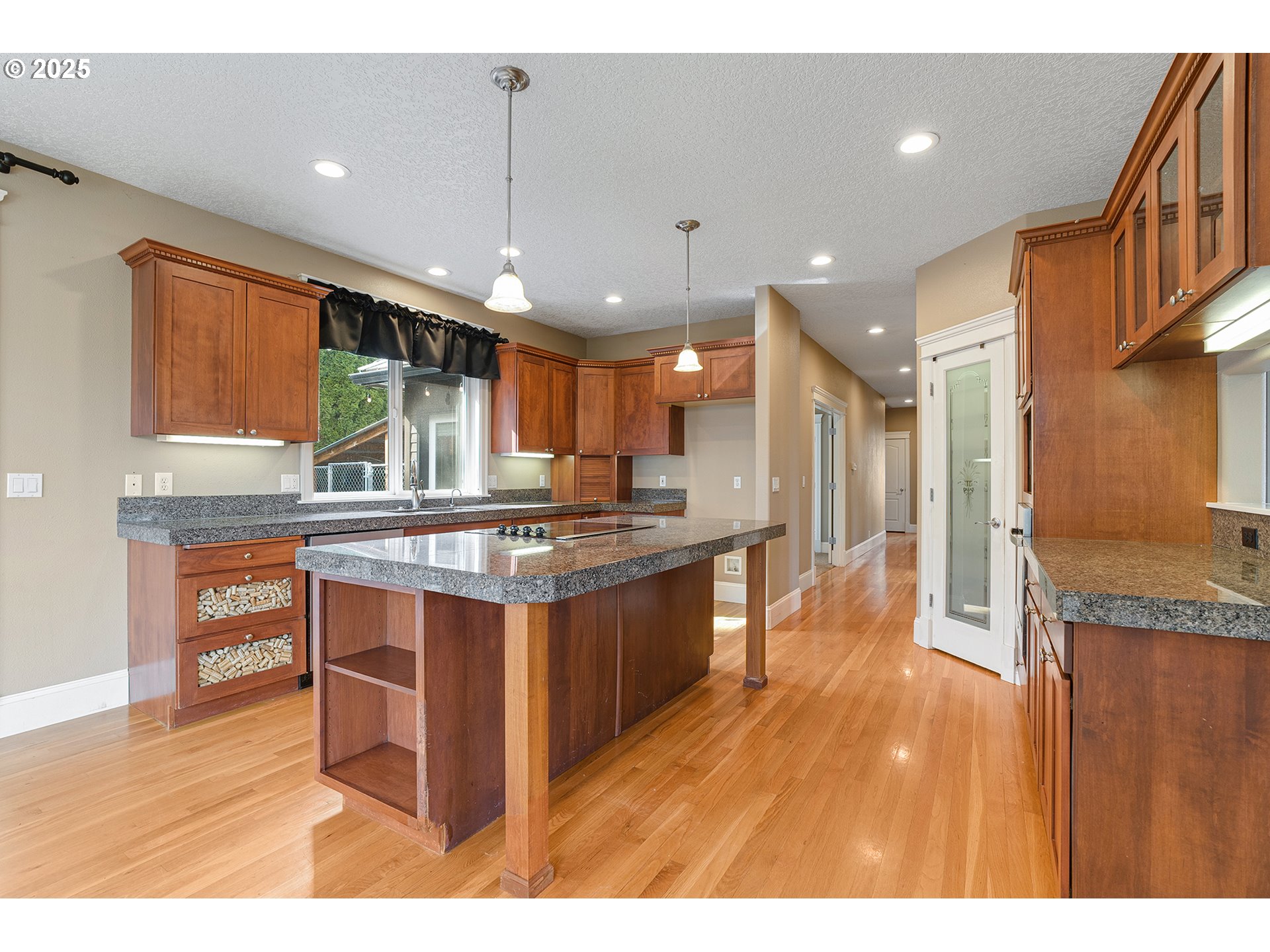 2947 Southeast Maple Place Gresham, OR 97080 - Photo 18 of 46 a kitchen with stainless steel appliances granite countertop a sink a stove and a wooden floors