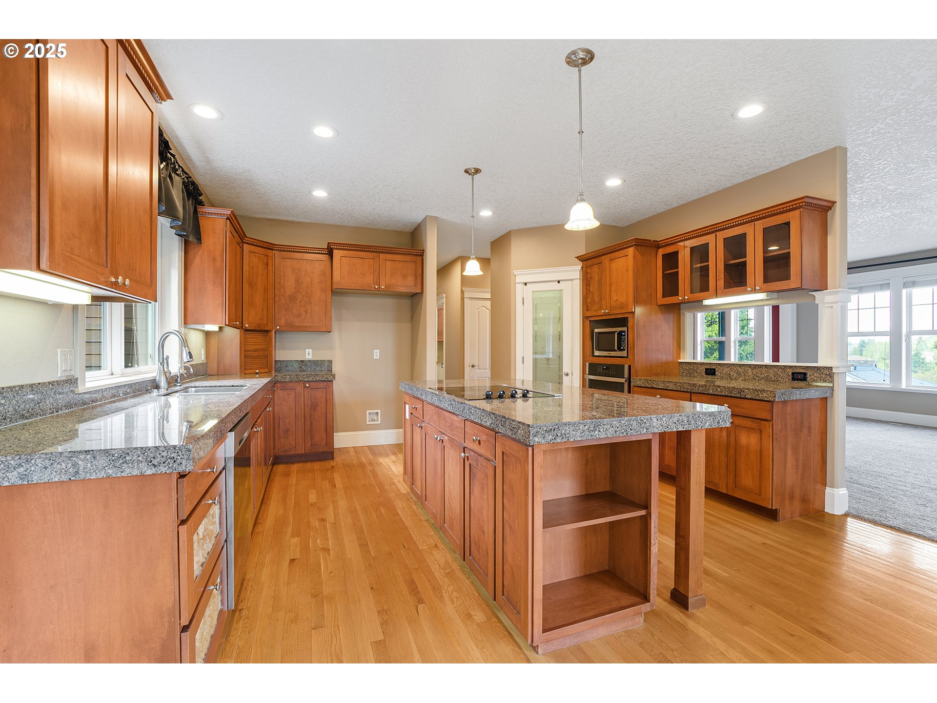 2947 Southeast Maple Place Gresham, OR 97080 - Photo 20 of 46 a kitchen with stainless steel appliances granite countertop a sink a stove and a wooden floors