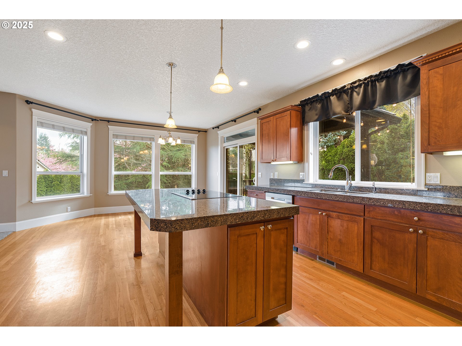2947 Southeast Maple Place Gresham, OR 97080 - Photo 22 of 46 a kitchen with stainless steel appliances granite countertop sink stove and wooden cabinets
