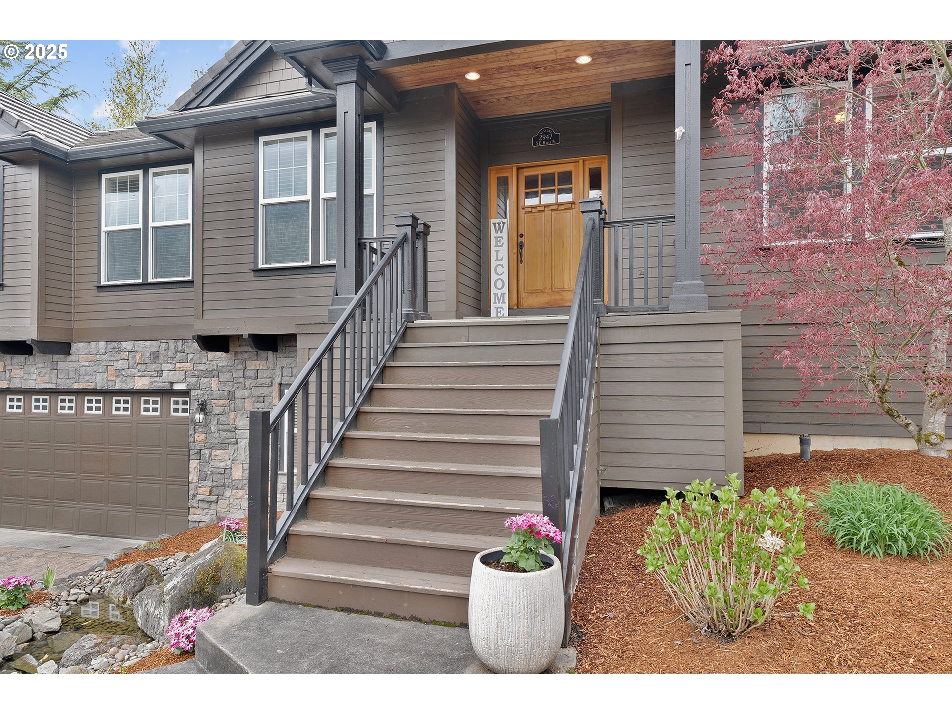 2947 Southeast Maple Place Gresham, OR 97080 - Photo 6 of 46 a view of a house with a potted plant and floor to ceiling window