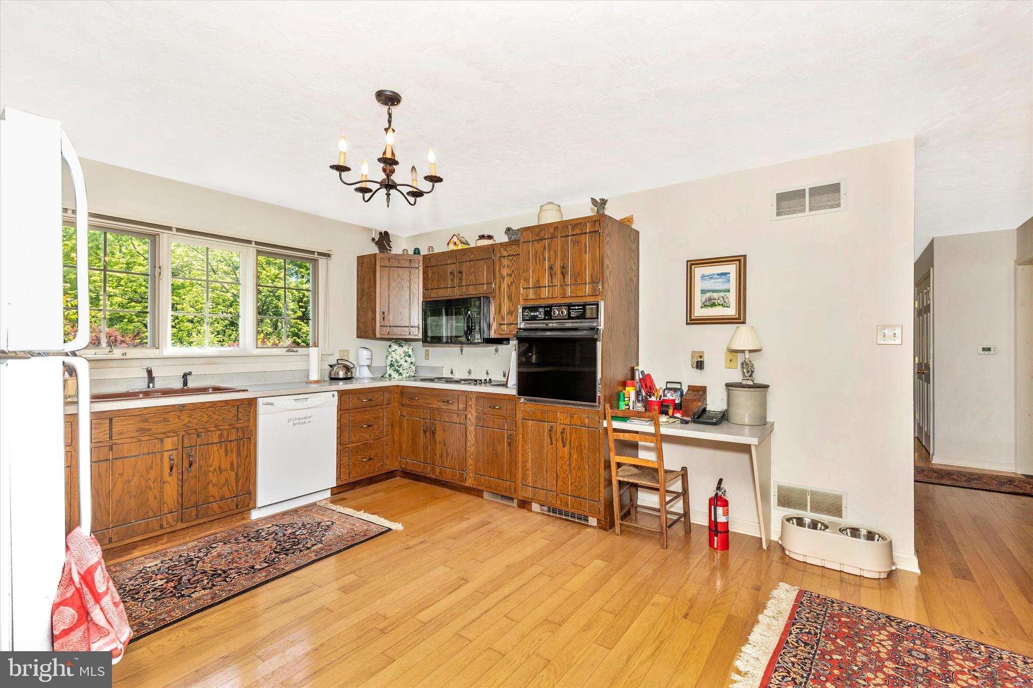 511 Stultz Road Fairfield, PA 17320 - Photo 33 of 86 a large kitchen with stainless steel appliances kitchen island granite countertop a refrigerator a stove a sink dishwasher and white cabinets with wooden floor
