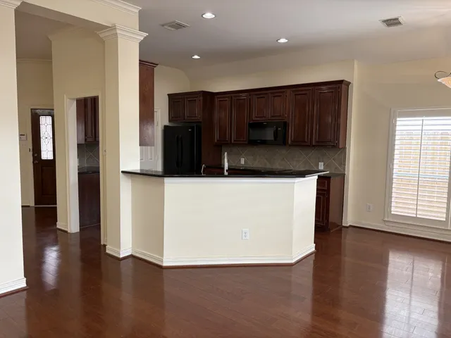 a kitchen with stainless steel appliances a refrigerator a sink a stove a microwave and cabinets