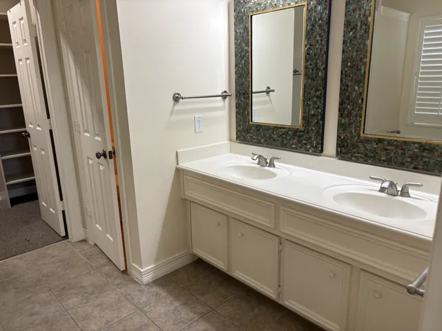 a bathroom with a double vanity sink and mirror