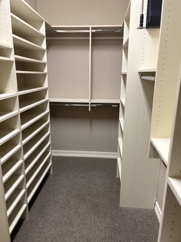 a view of an empty room with a staircase