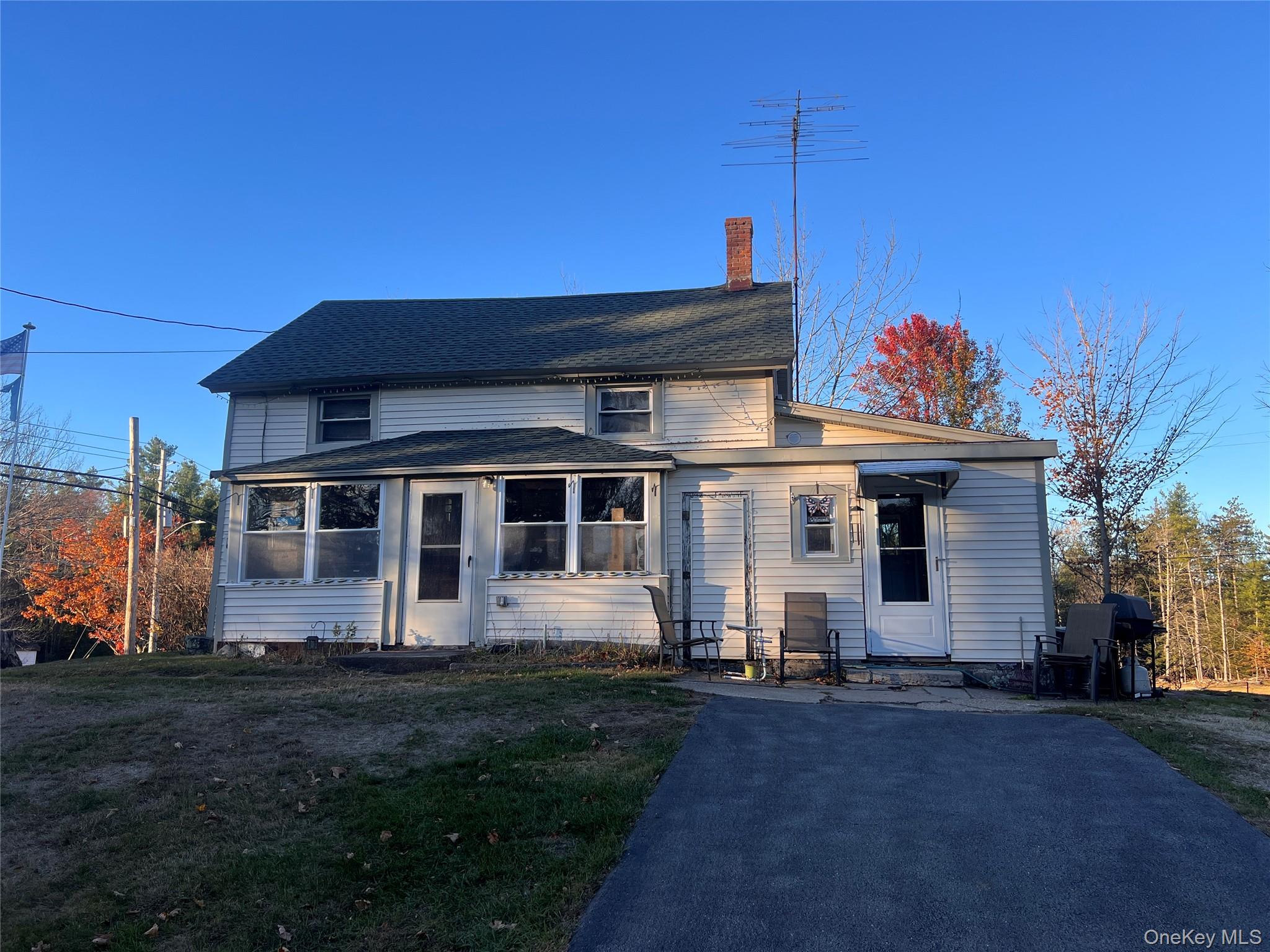 279 Cold Spring Road Monticello, NY 12701 - Photo 1 of 32 View of front facade featuring a chimney and a front yard