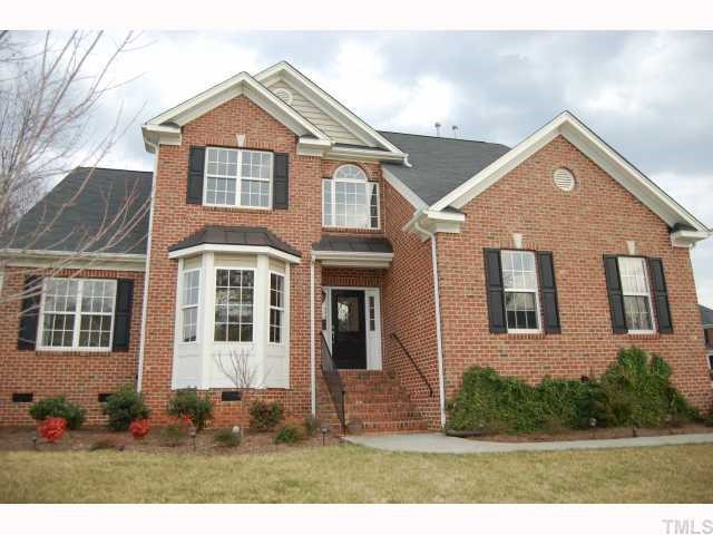 8620 Churchdown Court Raleigh, NC 27613 - Photo 1 of 12 a front view of a house with a yard