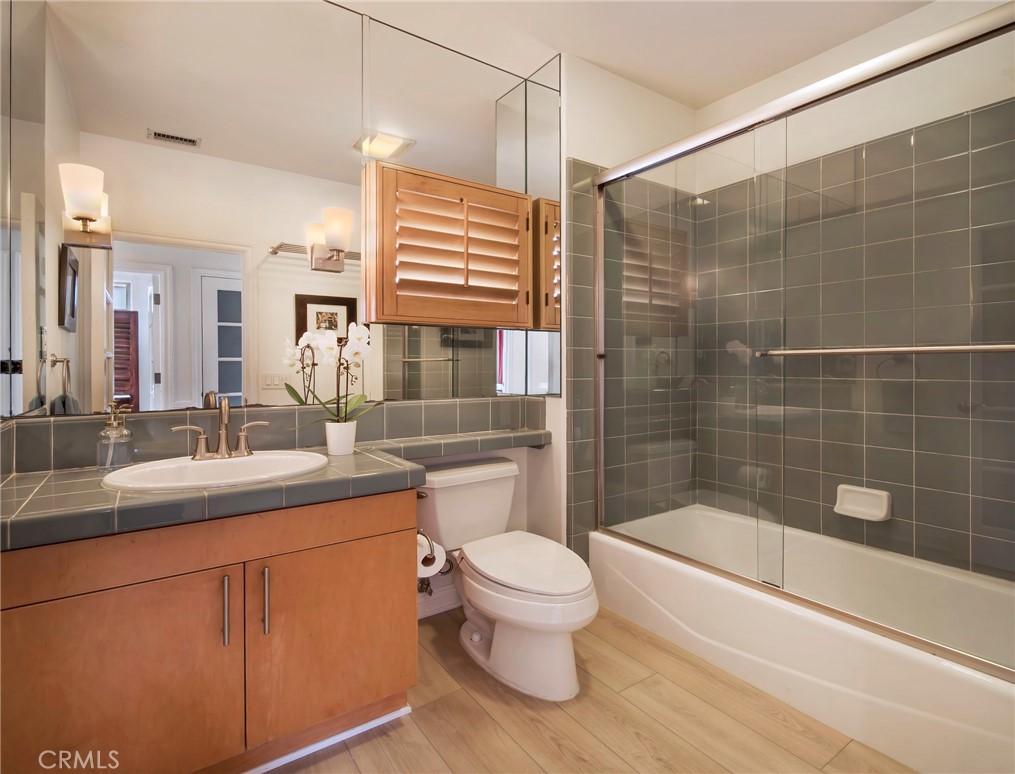 2741 Bungalow Place Corona del Mar, CA 92625 - Photo 12 of 29 a bathroom with a sink a toilet a mirror and bathtub