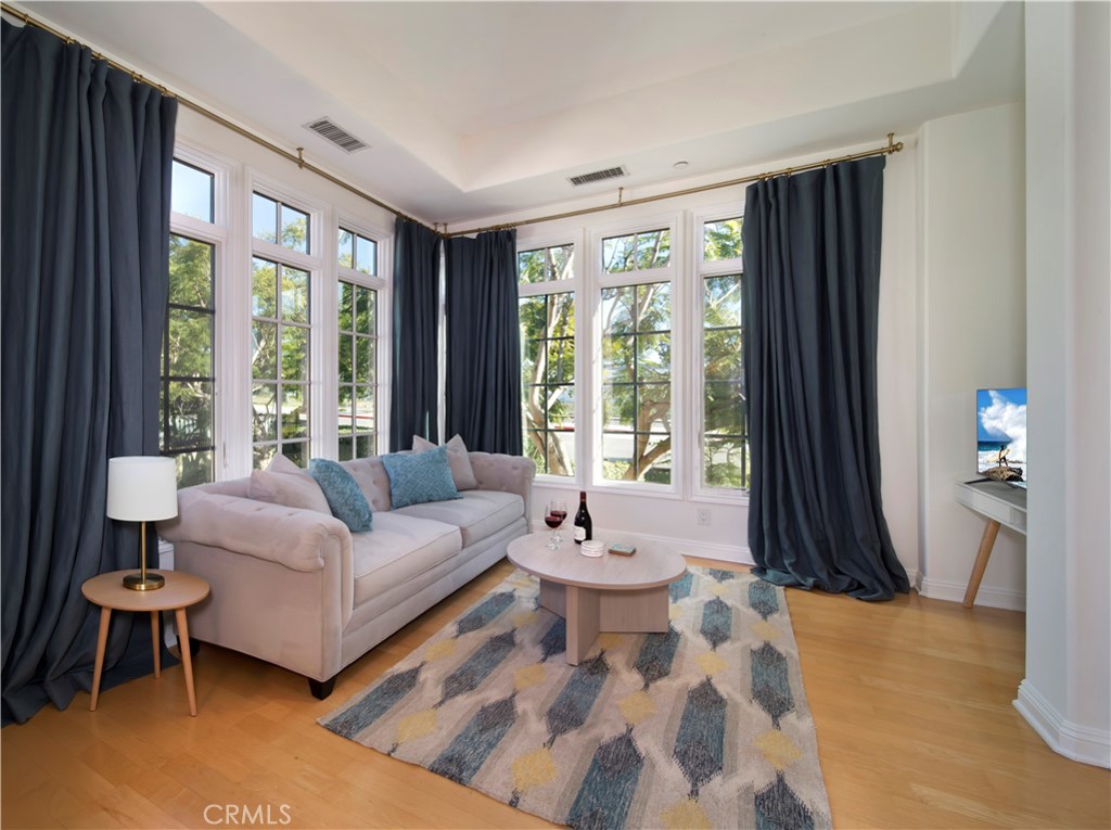 2741 Bungalow Place Corona del Mar, CA 92625 - Photo 2 of 29 a living room with furniture and a large window