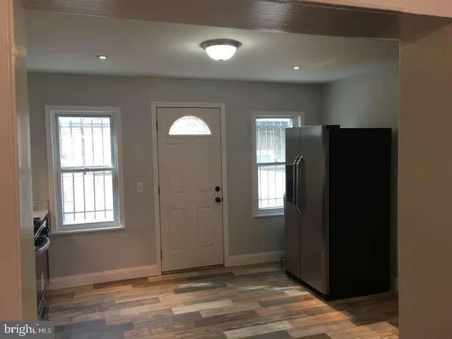 an empty room with windows and closet