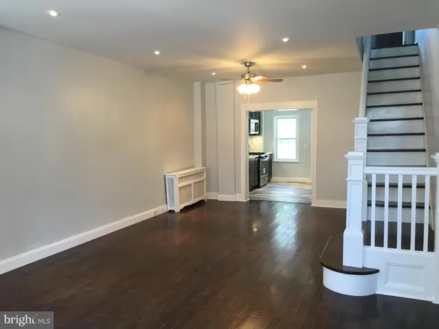 a view of kitchen and hall with wooden floor