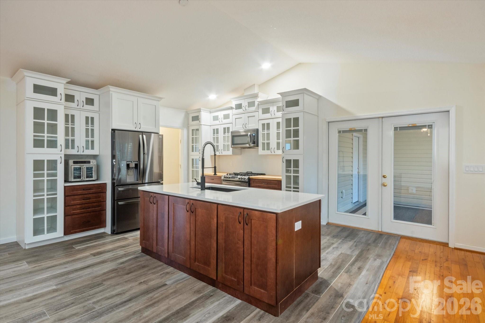 207 Allen Paul Road Hendersonville, NC 28791 - Photo 2 of 28 a kitchen with stainless steel appliances a refrigerator and wooden cabinets