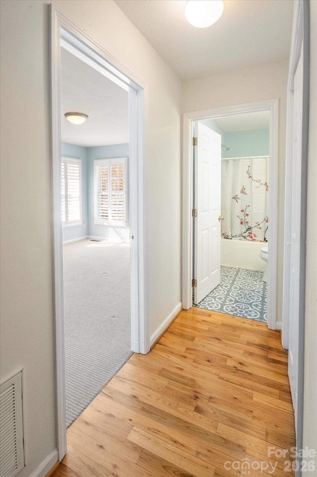 207 Allen Paul Road Hendersonville, NC 28791 - Photo 24 of 28 a bedroom with a bed and wooden floor