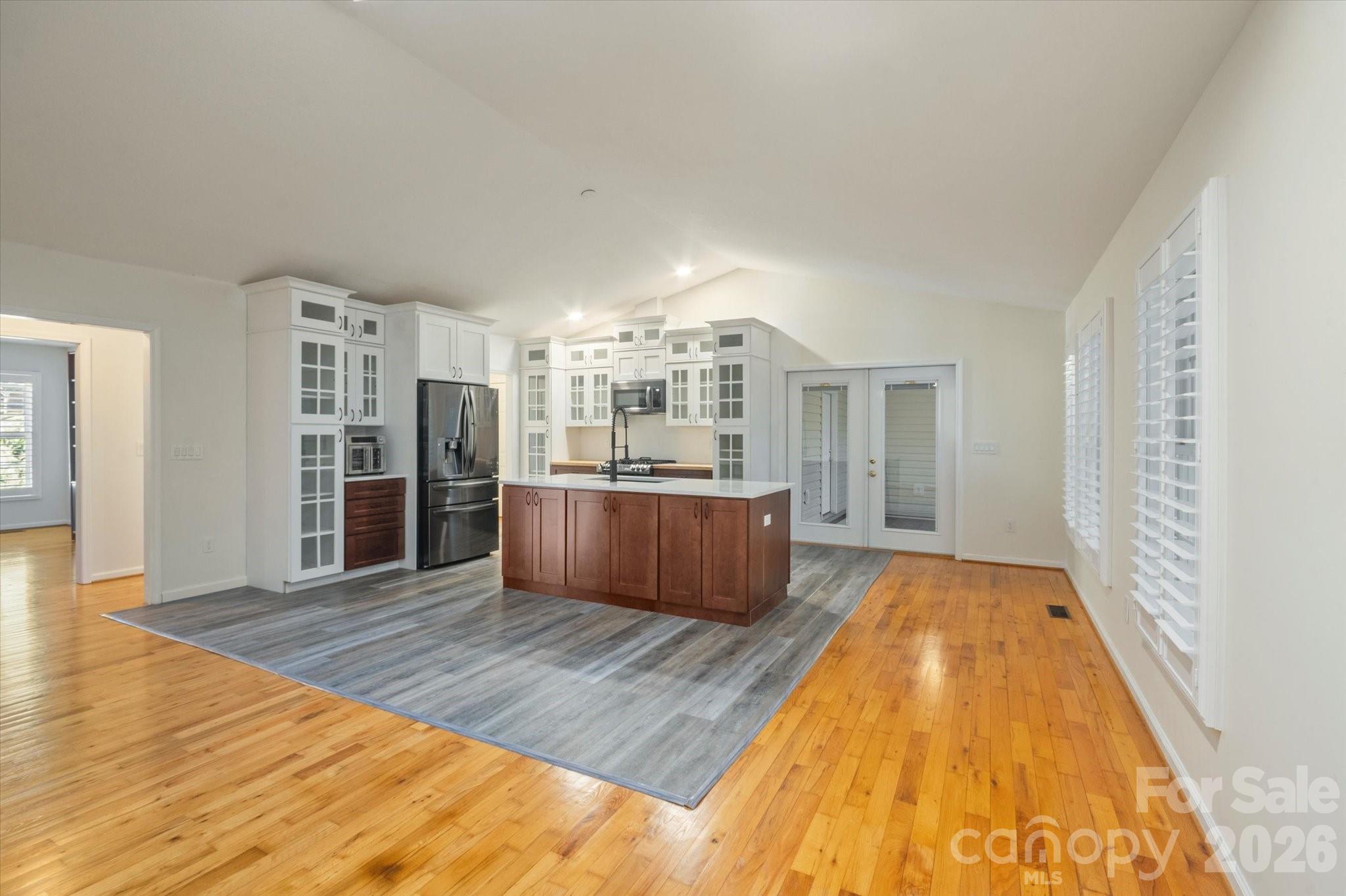 207 Allen Paul Road Hendersonville, NC 28791 - Photo 4 of 28 a large bedroom with wooden floor and a fireplace