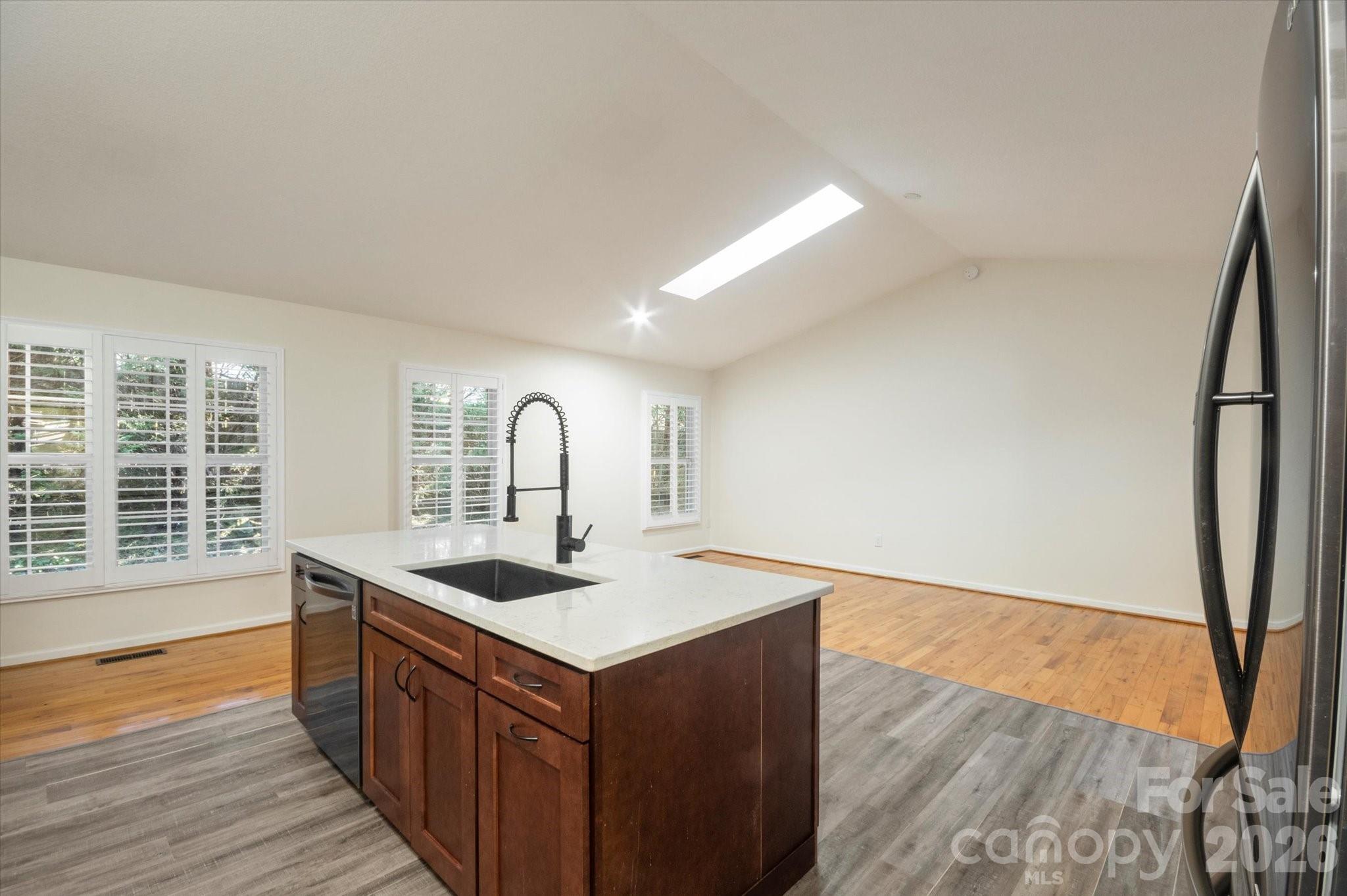 207 Allen Paul Road Hendersonville, NC 28791 - Photo 7 of 28 a kitchen with stainless steel appliances granite countertop a sink and a stove with wooden floor