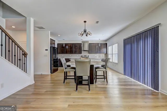 a view of a dining room with furniture and window