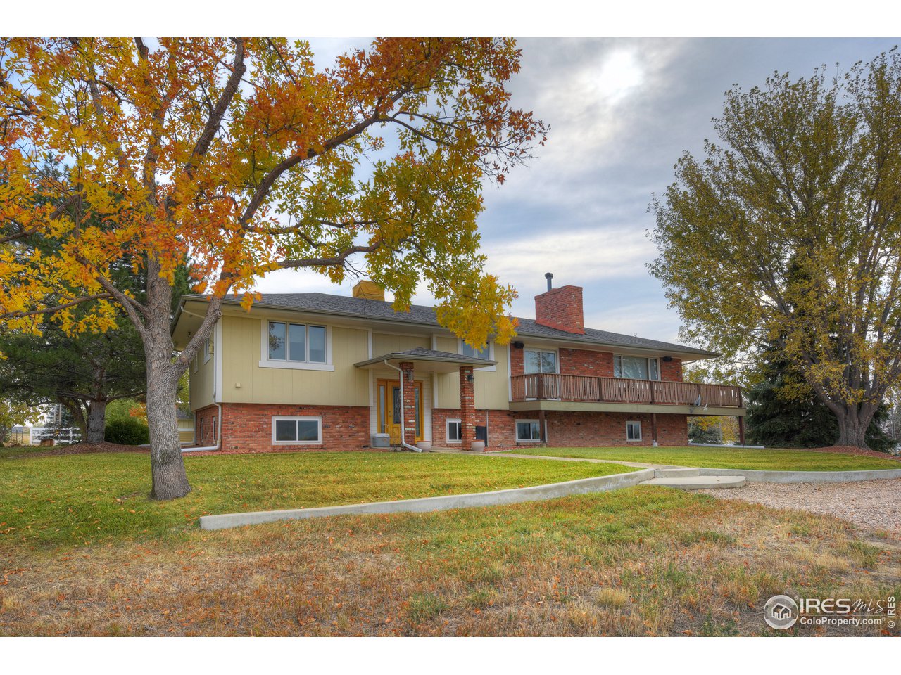 9505 Yellowstone Road Longmont, CO 80504 - Photo 4 of 37 a view of a big house with a big yard and large trees