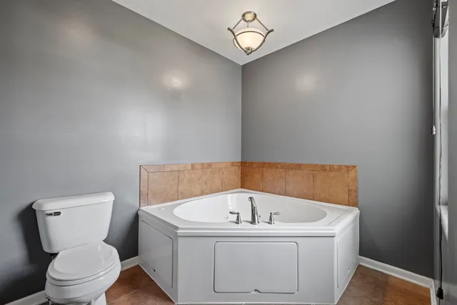 a white bath tub sitting next to a toilet