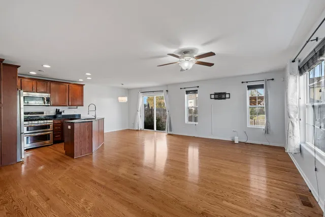 a view of kitchen with sink and refrigerator