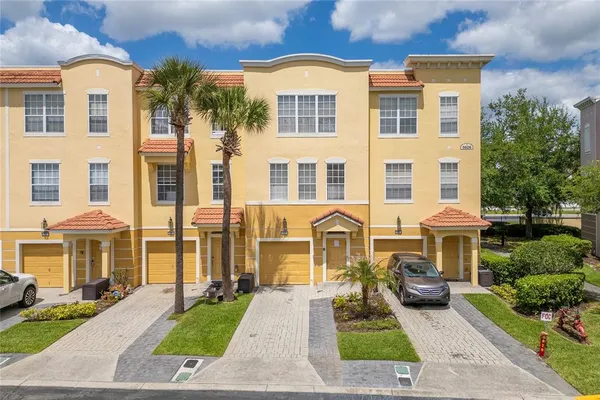 a front view of a residential apartment building with a yard