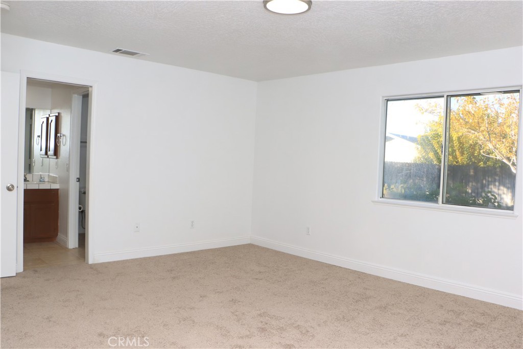 15742 Muscatel Street Hesperia, CA 92345 - Photo 11 of 24 an empty room with a window