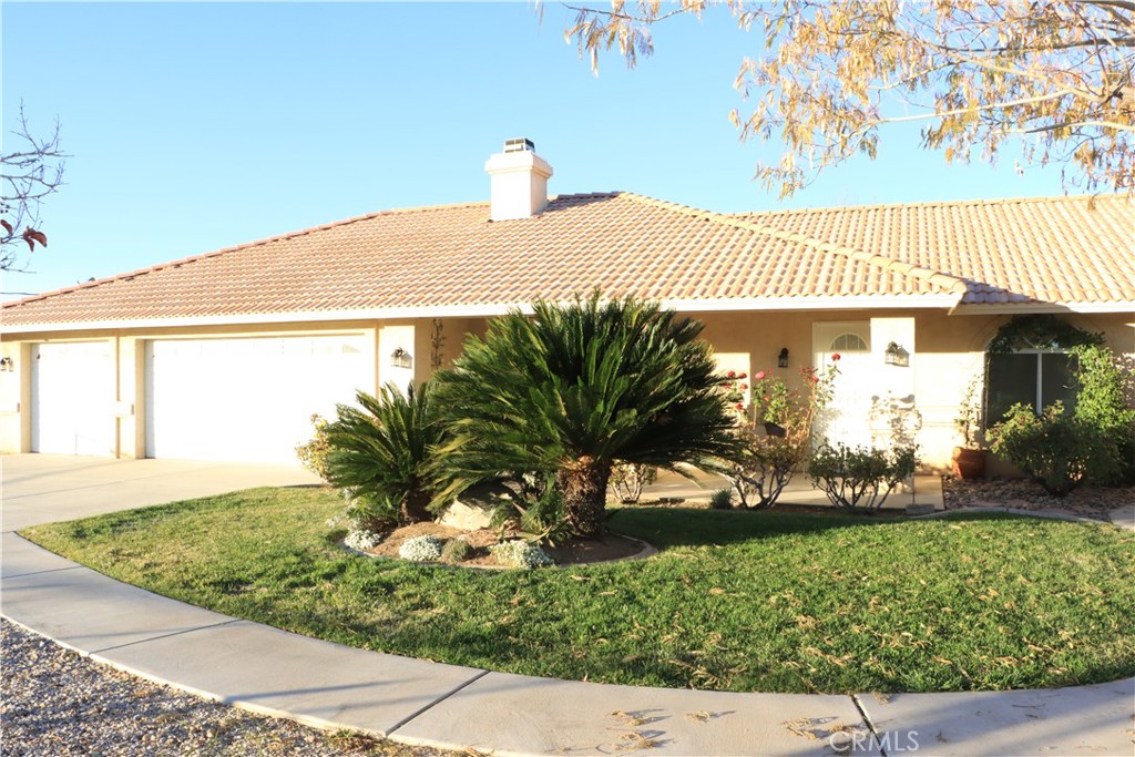 15742 Muscatel Street Hesperia, CA 92345 - Photo 21 of 24 a front view of a house with garden