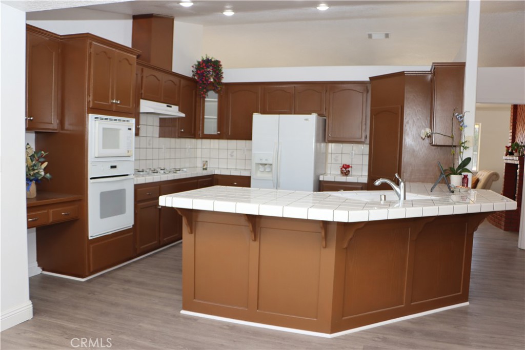 15742 Muscatel Street Hesperia, CA 92345 - Photo 5 of 24 a kitchen with stainless steel appliances granite countertop a sink and a stove