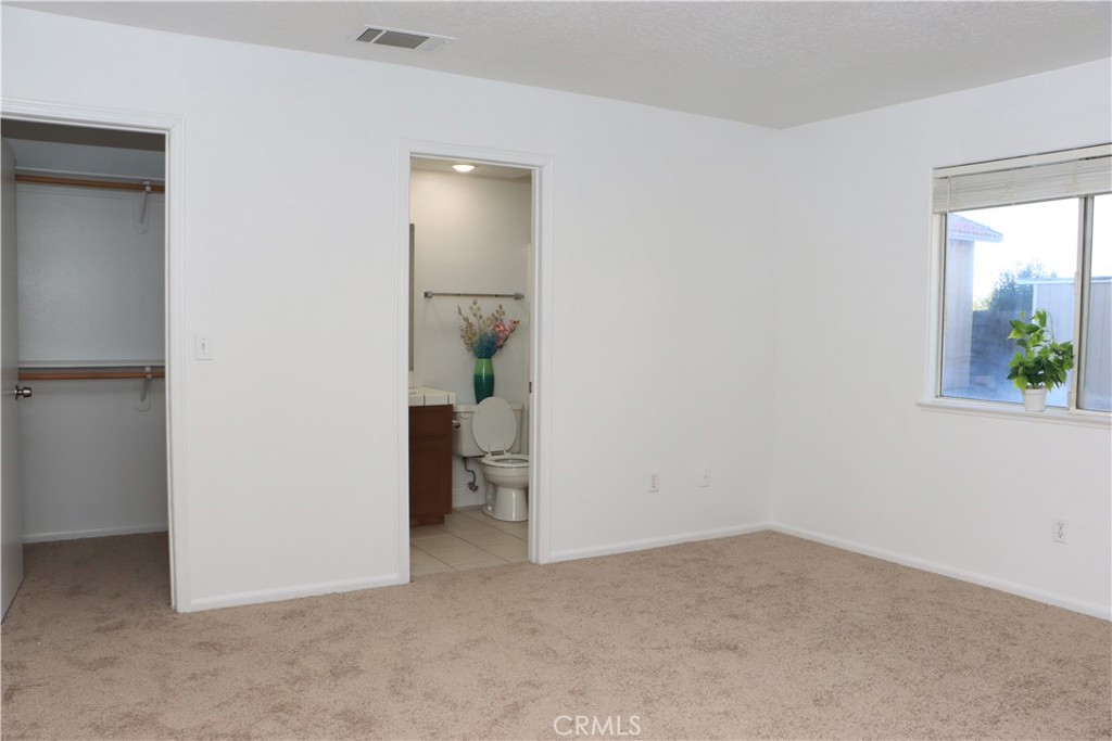 15742 Muscatel Street Hesperia, CA 92345 - Photo 7 of 24 an empty room with windows and closet