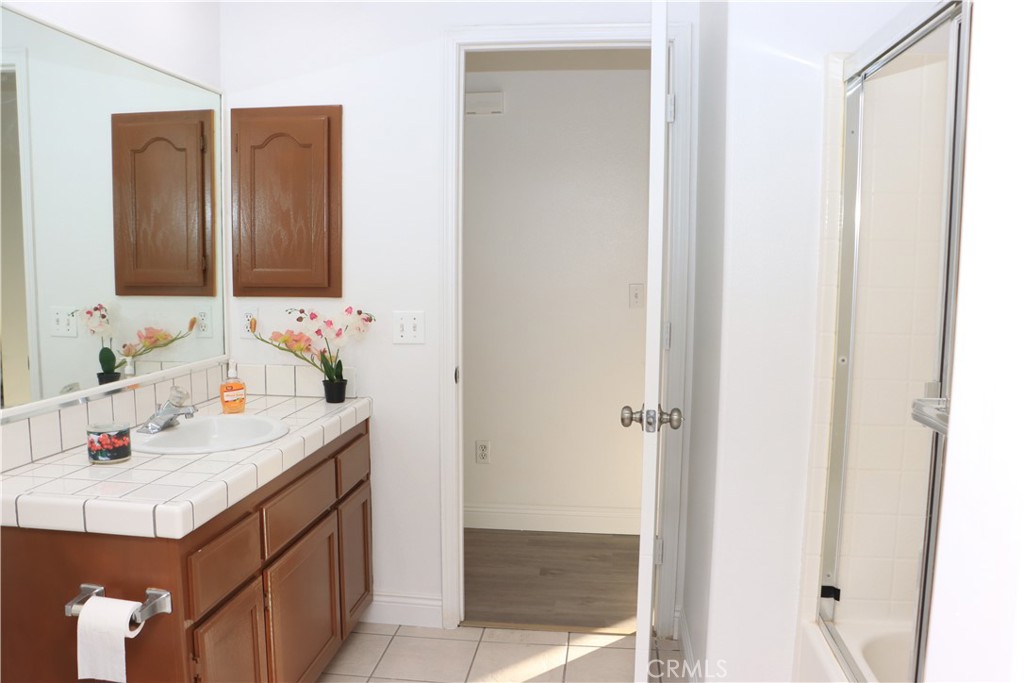 15742 Muscatel Street Hesperia, CA 92345 - Photo 9 of 24 a bathroom with a sink vanity and a mirror