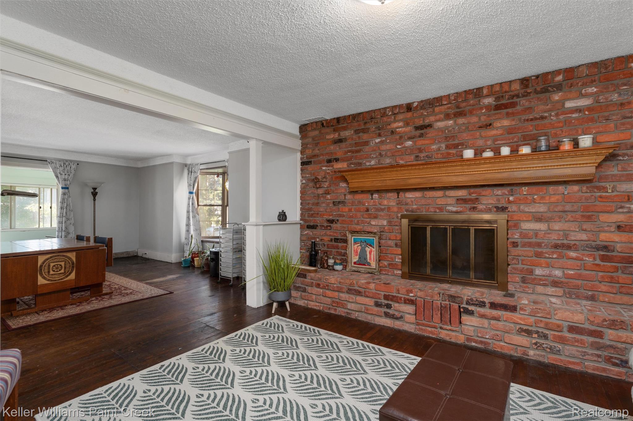 328 Ferndale Avenue Rochester, MI 48307 - Photo 20 of 54 Exposed brick fireplace with a wood mantel