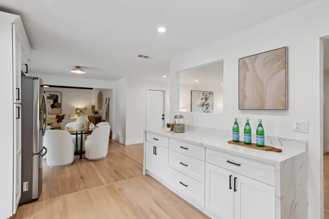 a kitchen with sink and refrigerator