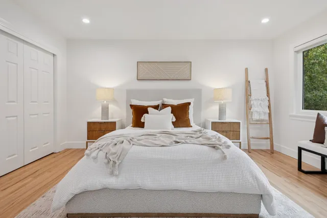 a bed room with a bed and a window